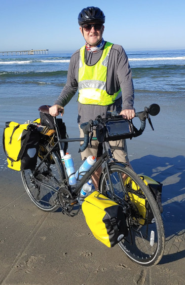Jim Beeson with his touring bike at the Pacific Ocean